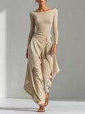 A beige top with a boat neckline and layered wide-leg pants.