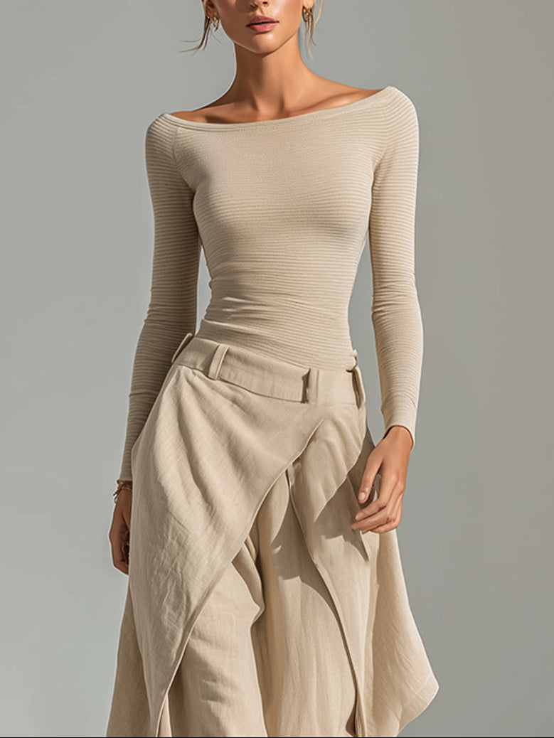 A beige top with a boat neckline and layered wide-leg pants.