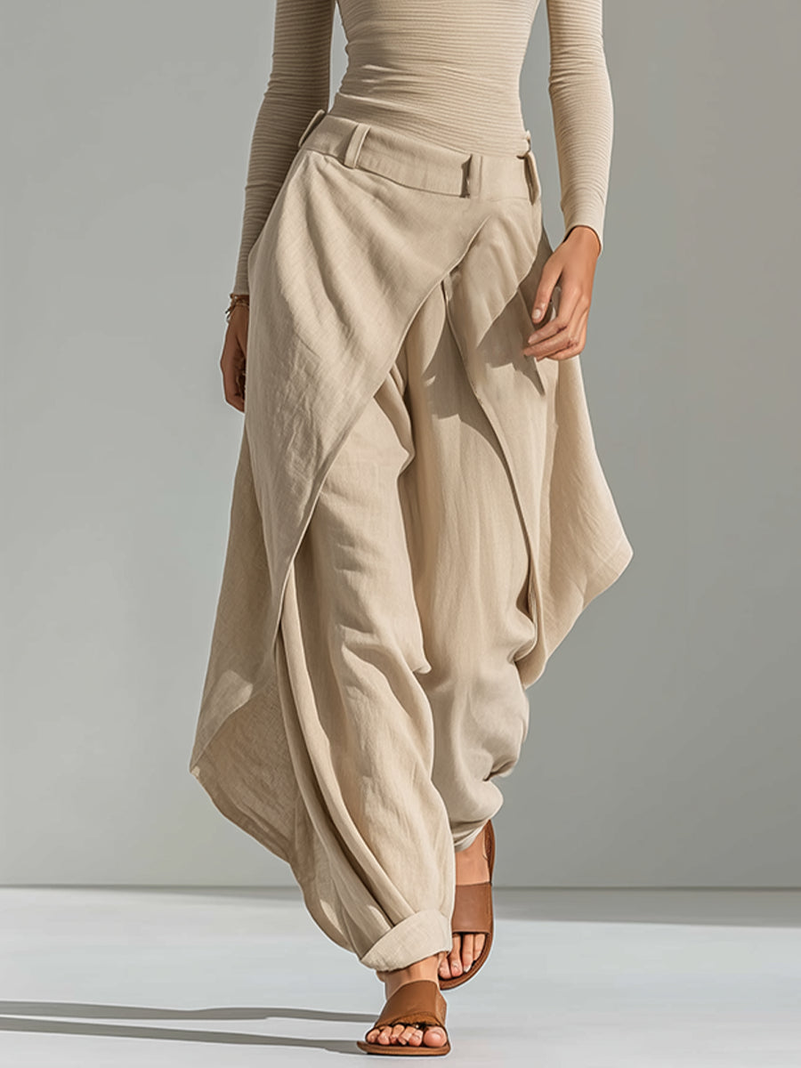 A beige top with a boat neckline and layered wide-leg pants.
