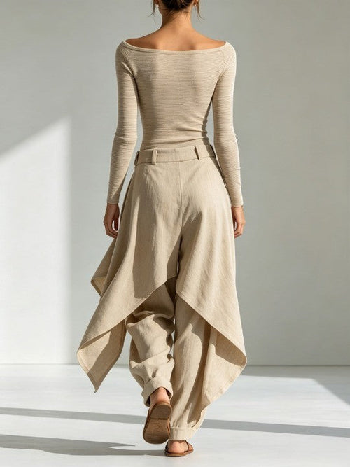 A beige top with a boat neckline and layered wide-leg pants.